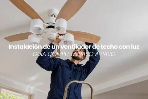 Hombre instalando un ventilador de techo con luz. Guía completa para montar tu ventilador.