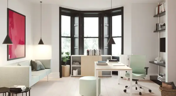 Un moderno despacho en casa con sofá, escritorio, silla ergonómica y estanterías.